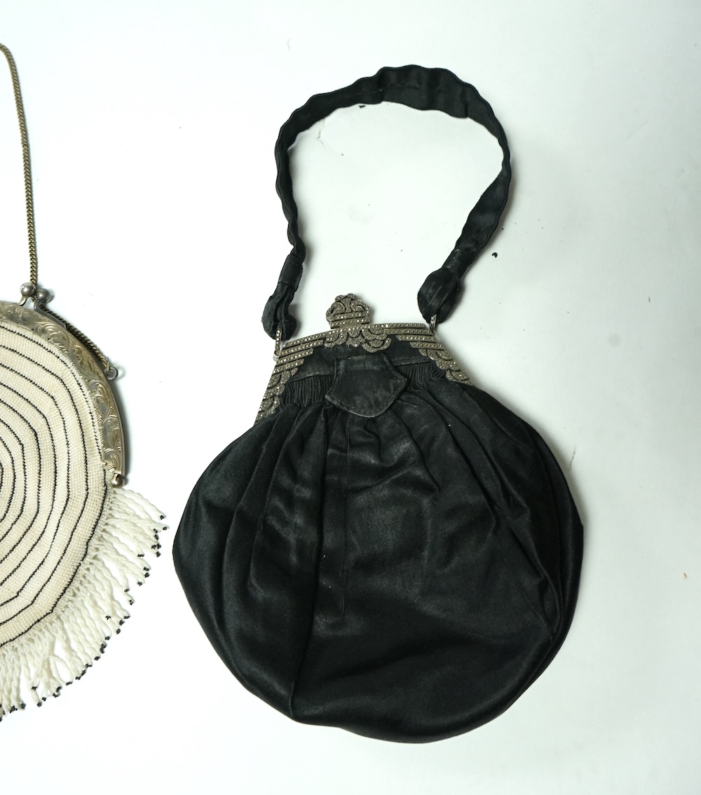 A 1930’s black and white finely beaded evening bag with a German 830 standard stamped metal frame together with a marcasite framed black satin bag and a brown quilted bag with an ornate paste set gilt frame. Largest 21.5